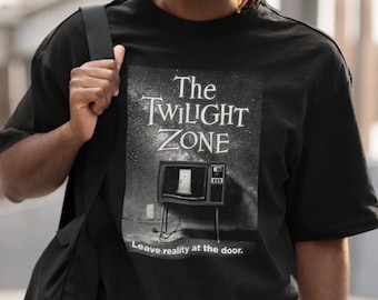 May include: A black t-shirt with a graphic of a vintage television set with the text "The Twilight Zone" and the words "Leave reality at the door."