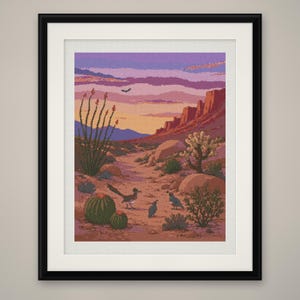 May include: A framed art print depicting a desert landscape at sunset with purple and orange skies. The scene features a roadrunner, two quail, barrel cacti, and ocotillo plants against a backdrop of rocky cliffs and distant mountains.