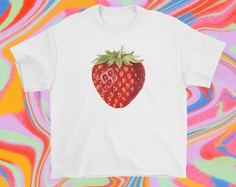 May include: White t-shirt with a red strawberry graphic. The strawberry is detailed with a green stem and leaves.