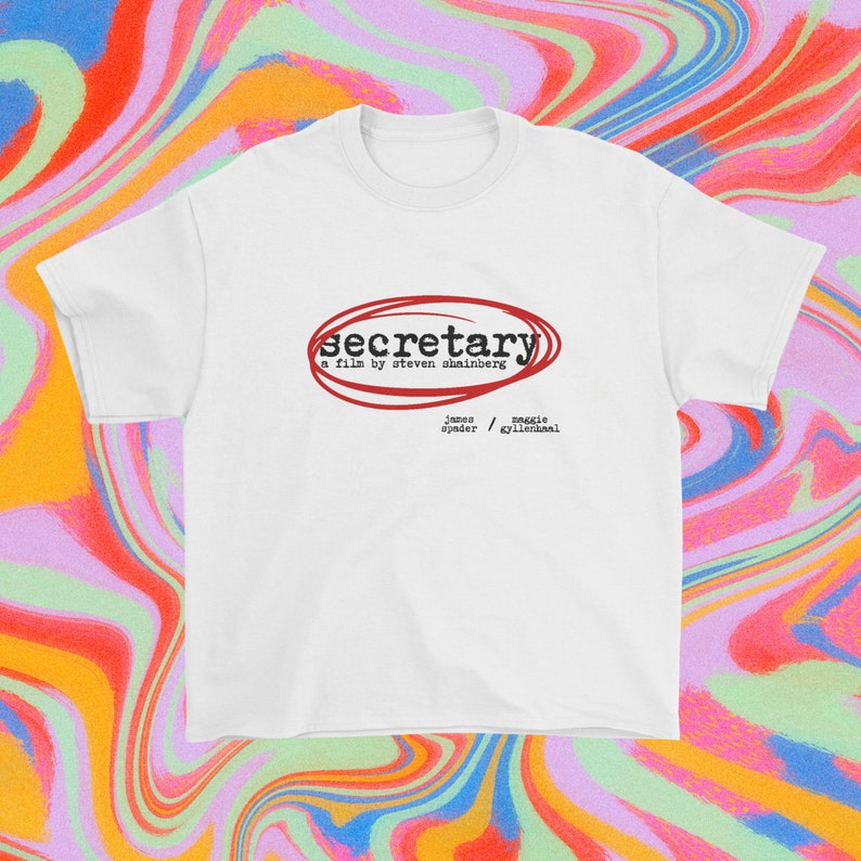May include: White t-shirt with a red circle around the word "secretary" and the text "a film by Steven Shainberg" below. The names "James Spader" and "Maggie Gyllenhaal" are listed below the title.
