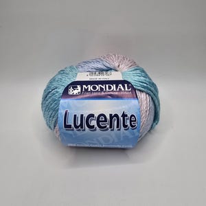 May include: A skein of blue, white, and pink yarn with the label "MONDIAL Filati Lana & Cotone ITALIA Lucente 50% Cotone - Cotton - Baumwolle - Coton"