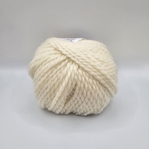May include: A ball of off-white yarn with a white label.