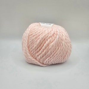 May include: A ball of soft, pink yarn. The yarn is a chunky weight and has a slightly textured look.