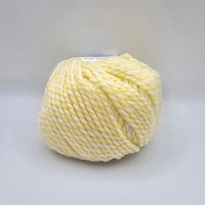 May include: A ball of yellow and white yarn with a twisted texture.