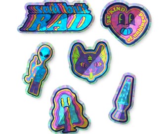 May include: Six holographic stickers with various designs. The stickers feature a cat, an alien, a lava lamp, a mushroom, and two text-based designs. One sticker says "Sad but Rad" and the other says "Be Kind of Unhinged".
