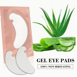 May include: Two white crescent-shaped gel eye pads in a pink pouch with a green aloe vera plant and the text "GEL EYE PADS 100% NON IRRITATING".
