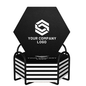 May include: A black hexagonal coaster with a white logo and the text "YOUR COMPANY LOGO". The coaster is set in a black metal frame with a stack of white and black striped coasters. The design is modern and minimalist.