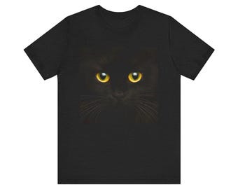 May include: Black t-shirt with a black cat face graphic. The cat's eyes are bright yellow.