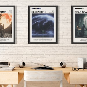 May include: Three framed posters on a white brick wall. The posters are for the video games Bloodborne, Elden Ring, and Dead Space. The posters are all in a minimalist style with black frames and white text.