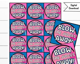 May include: A printable set of 12 square cards with a pink and blue background. Each card features a white circle with the text "Blow the Judges Away!" in black text. The cards are designed for a game or activity.