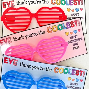 K&ouml;nnte beinhalten: Drei Valentinstagskarten mit dem Text "EYE think you're the COOLEST!" und einer Herz-Sonnenbrille auf jeder Karte. Die Sonnenbrillen sind rot, pink und blau.
