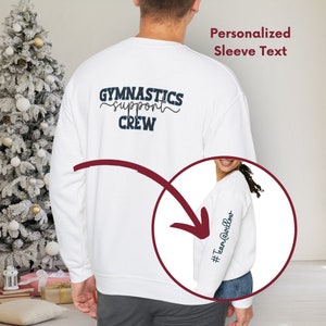 May include: White sweatshirt with the text "Gymnastics support crew" on the back and the text "#TeamAwesome" on the sleeve.