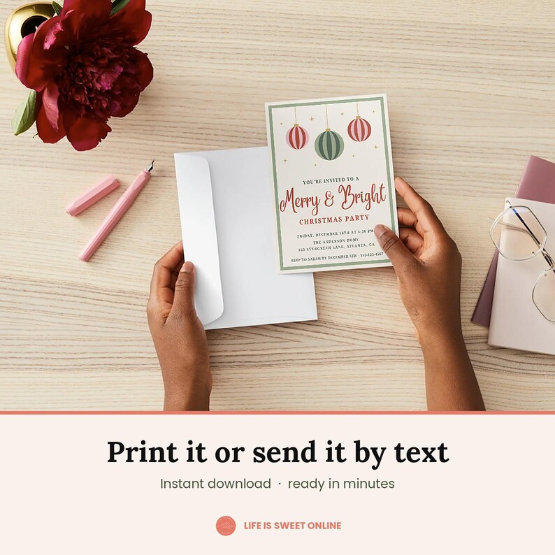May include: A rectangular Christmas party invitation card featuring three hanging ornaments in red and green, with the text Merry & Bright Christmas Party, date, time, and location details, held alongside a plain white envelope on a wooden surface.