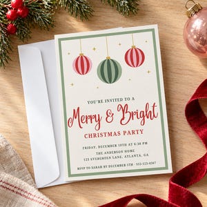 May include: A rectangular Christmas party invitation card with a green border, featuring three hanging ornaments in pink, green, and red. The text reads: You're invited to a Merry & Bright Christmas party, Friday, December 18th at 6:30 PM, The Anderson Home, 123 Evergreen Lane, Atlanta, GA, RSVP to Sarah by December 5th, 555-123-4567.