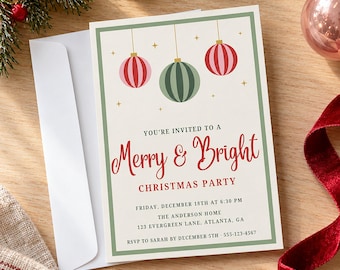 May include: A rectangular Christmas party invitation card with a green border, featuring three hanging ornaments in pink, green, and red. The text reads: You're invited to a Merry & Bright Christmas party, Friday, December 18th at 6:30 PM, The Anderson Home, 123 Evergreen Lane, Atlanta, GA, RSVP to Sarah by December 5th, 555-123-4567.