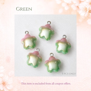 May include: Five star-shaped charms with a pearlescent finish, featuring a gradient of soft pink at the edges transitioning to a creamy white center and light green base. Each charm includes a small silver-toned metal jump ring at the top.