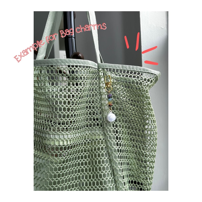 May include: A light green mesh tote bag featuring a gold-toned lobster clasp bag charm with small multicoloured beads and a single white spherical bead. The text "Example for Bag charms" is written in pink script across the upper left corner.