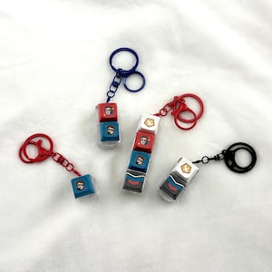 Peacemaker Vigilante Clicky Keychains