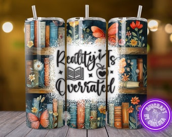 May include: A white tumbler with a black and white graphic of books on a shelf with flowers and butterflies. The text "Reality is Overrated" is printed on the tumbler.