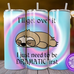 Puede incluir: Un vaso de acero inoxidable con un diseño tie-dye rosa, azul y morado. El vaso presenta un perezoso de dibujos animados y el texto "I'll get over it I just need to be dramatic first".