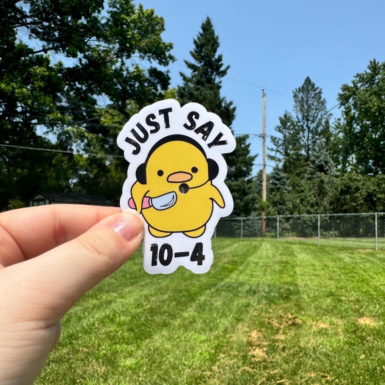 May include: A white sticker featuring a yellow cartoon duck wearing a headset and holding a knife. The sticker has the words "JUST SAY" above the duck and "10-4" below it.