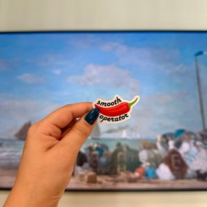 May include: A red chili pepper sticker with the text "smooth operator" on a white background.