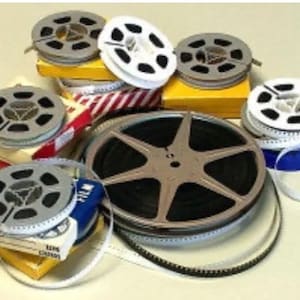 Roll of 8mm film reel on film with an old movie - Stock Photo