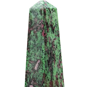 May include: A green and pink zultanite gemstone obelisk with a pointed top and a smooth, polished surface.
