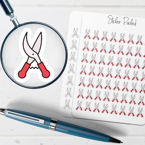 May include: A sticker sheet with multiple illustrations of red-handled pruning shears. A single sticker of the same shears is magnified by a magnifying glass. A blue pen is in the foreground. The sticker sheet has the text "Sticker Packed".