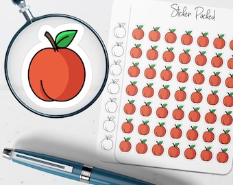 May include: A sticker sheet with multiple red apple stickers with green leaves. A large peach sticker is magnified by a magnifying glass. A blue pen is also in the image. The text "Sticker Packed" is visible.