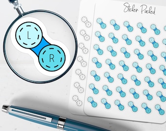 May include: A sheet of stickers with contact lens designs, featuring the letters "L" and "R" in a light blue color. The stickers are arranged on a white background, with a magnifying glass and a blue pen in the foreground. The text "Sticker Packed" is visible.