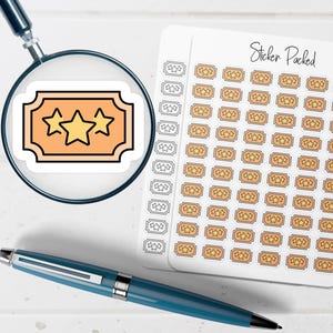 May include: A sticker sheet with multiple small, orange ticket-shaped stickers, each featuring three yellow stars. A larger sticker with the same design is magnified by a magnifying glass. A blue pen is also in the image.
