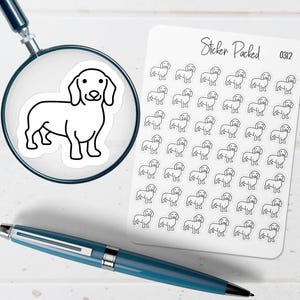 May include: A sheet of stickers with a repeating outline of a dachshund dog. The stickers are black and white. A magnifying glass shows a close-up of one sticker. A blue pen is in the foreground.