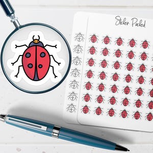 May include: A magnifying glass focuses on a ladybug sticker with a red body and black spots. A sheet of ladybug stickers and the words "Sticker Packed" are visible. A blue pen lies in the foreground.
