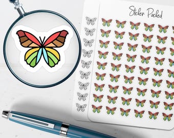 May include: A sticker sheet labeled Sticker Packed featuring rows of small butterfly stickers in rainbow colors and black and white outlines, with a magnifying glass showing a single butterfly sticker and a blue pen positioned below the sheet.