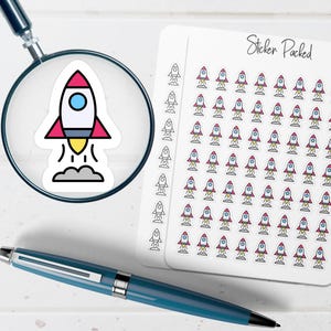 May include: A sheet of stickers with a rocket ship design. The rocket is white with red and blue accents, and a yellow flame. The stickers are on a white background, with the words "Sticker Packed" in black script.