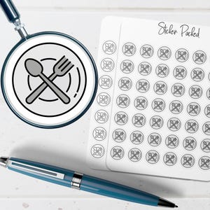 May include: A magnifying glass focuses on a black and white spoon and fork icon. A sheet of stickers with the text "Sticker Packed" and a blue pen are also visible. The stickers feature the same spoon and fork icon.