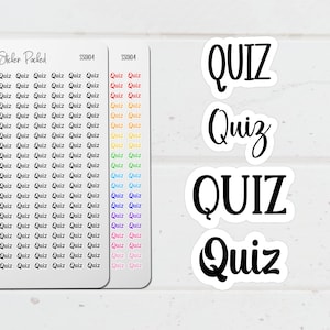 May include: White stickers with the word "QUIZ" in various fonts. Two sheets of stickers are visible, one with the text "Quiz" repeated in rows and columns, and the other with the word "Quiz" in a rainbow of colors.