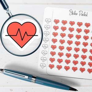 May include: A sheet of stickers with red heart and heartbeat line designs. A large heart sticker is viewed through a magnifying glass. A blue pen is also in the image. The sheet of stickers has the text "Sticker Packed".