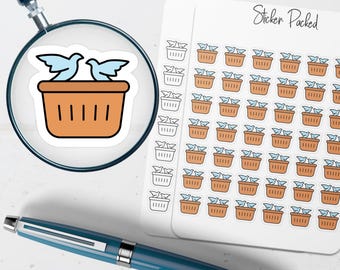 May include: A sheet of stickers featuring a repeating pattern of light blue birds in brown baskets. The stickers are labeled "Sticker Packed". A magnifying glass focuses on a single sticker with two birds in a basket.