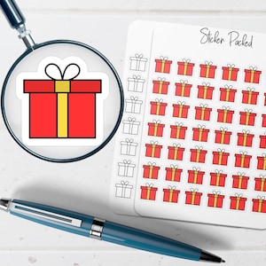 May include: A sheet of stickers with a repeating pattern of red gift boxes with yellow ribbons. One sticker is magnified by a magnifying glass. The words "Sticker Packed" are written in cursive on the sheet. A blue pen is in the foreground.
