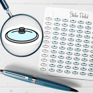 May include: A sheet of stickers featuring a light blue and gray pot lid design. The stickers are arranged in rows and columns. The words "Sticker Packed" are written in cursive at the top right. A blue pen and a magnifying glass are also in the image.