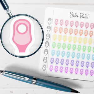 May include: A pink sticker is magnified by a magnifying glass. A sheet of colorful stickers is next to the magnifying glass. The sheet of stickers has the text "Sticker Packed" written on it. A blue pen is in the foreground.