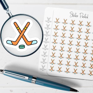 May include: A sheet of stickers with hockey stick and puck designs. The stickers are orange, blue, and green. The words "Sticker Packed" are written in cursive on the sheet. A magnifying glass and a blue pen are in the image.