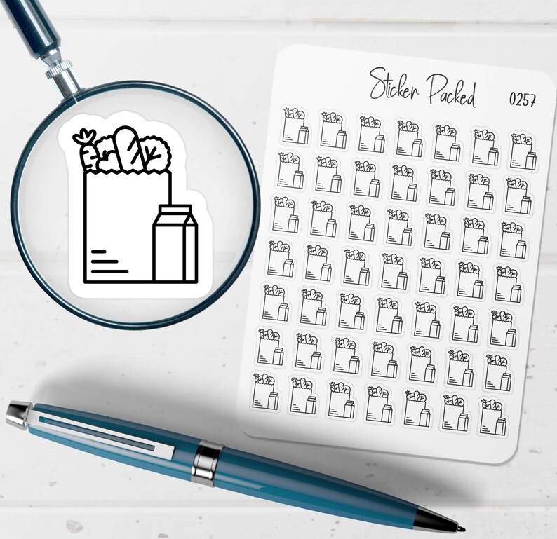May include: A sheet of stickers with a grocery bag and milk carton design. The stickers are black and white. The words "Sticker Packed" and the number "0257" are printed on the sheet. A blue pen and a magnifying glass are also in the image.