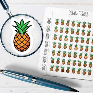 May include: A sheet of pineapple stickers with a magnifying glass over a single pineapple sticker. The stickers are orange and yellow with green tops. The text "Sticker Packed" is on the sheet. A blue pen is in the foreground.