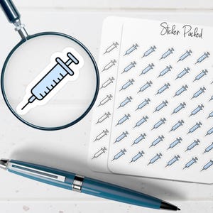 May include: A sticker sheet with multiple syringe stickers, a single syringe sticker under a magnifying glass, and a blue pen. The stickers are light blue and black. The text "Sticker Packed" is written on the sticker sheet.