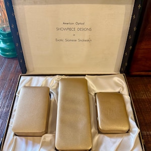 1950s American Optical Showpiece Set, Eyeglass Case, Keyrings, Cigarette Case