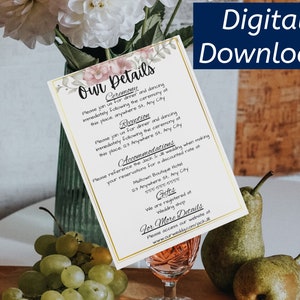 May include: A white wedding invitation card with gold trim and floral accents. The card includes details for the ceremony, reception, accommodation, and gifts. The text on the card reads "Our Details", "Ceremony", "Reception", "Accommodation", "Gifts", and "For More Details".