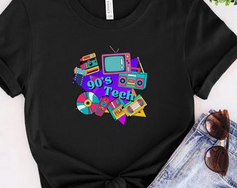 May include: Black t-shirt with a graphic of 90's tech items, including a TV, cassette player, camera, and film reel. The text "90's Tech" is in a colorful, retro font.